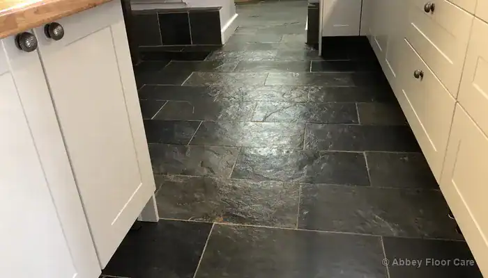 Restored green-black slate floor with clean grout and even sheen